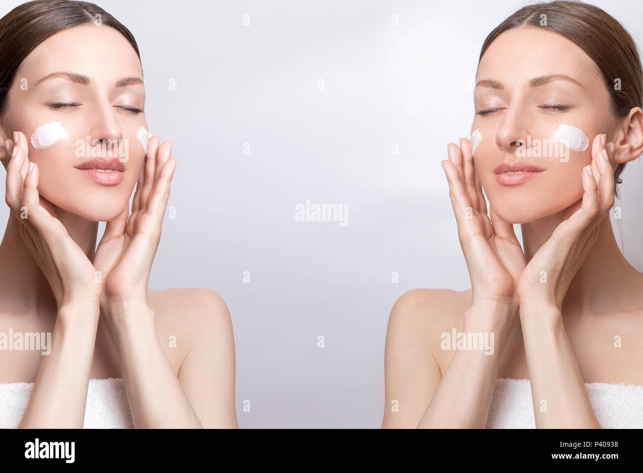 Ritratto di donna bella applicando una crema per il viso di lei per la cura della pelle Foto Stock