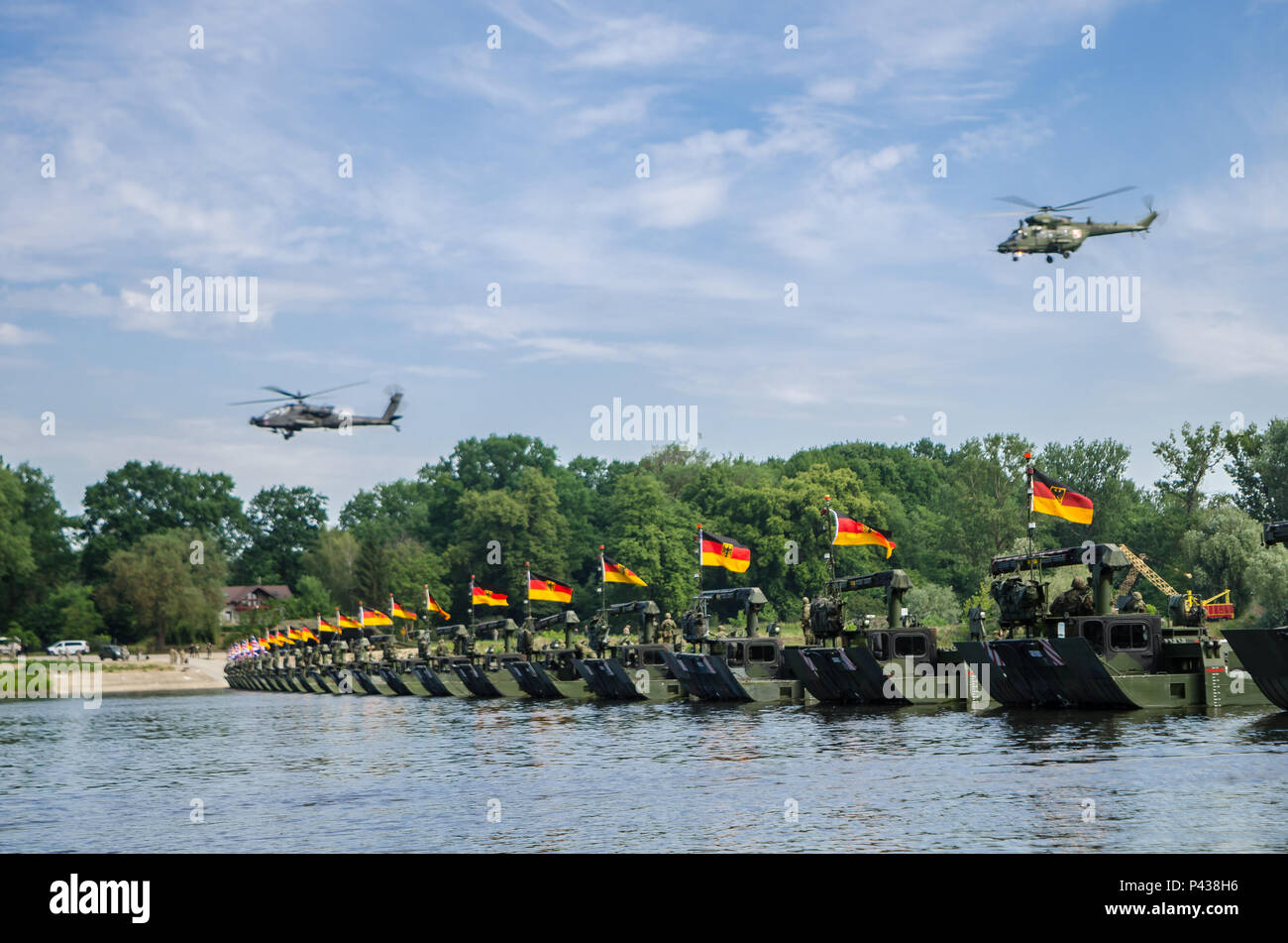 Elicotteri volare sopra le truppe su un ponte affrettate durante un ponte che attraversa il funzionamento in Chelmno, Polonia, Giugno 8, 2016. Forze multinazionali coordinati, assemblato e quindi attraversato un ponte costituito da tedesco e inglese M3 Rig anfibio, permettendo che i veicoli per attraversare il fiume Vistola come una parte di esercizio Anakonda 2016. Il polacco-led esercizio è un collettivo sforzo di formazione per rafforzare l'interoperabilità e rafforzare i legami tra gli alleati della NATO e partner, collettivo per garantire la pace e la sicurezza nella regione. Foto Stock