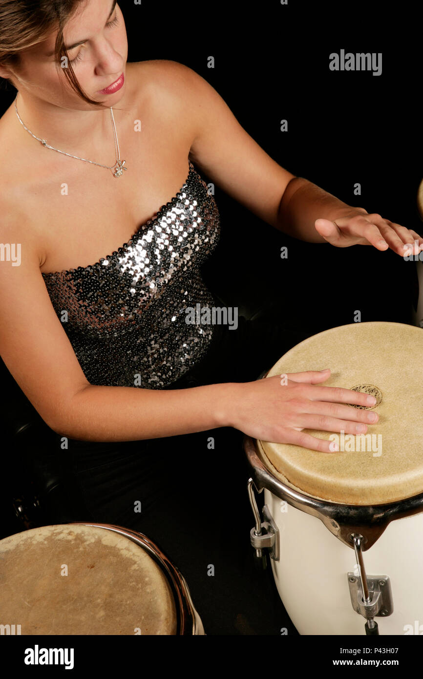 Giovane donna giocando conga in una band Foto Stock