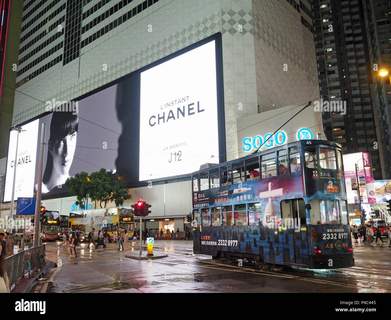 Vista di un tram si è fermato a notte nella parte anteriore del negozio Sogo sulla Hennessy Road in Causeway Bay Hong Kong Foto Stock