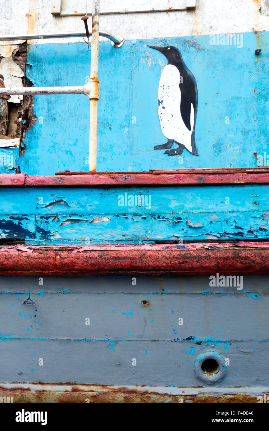 Penguin design sul lato di weathered barca da pesca Foto Stock