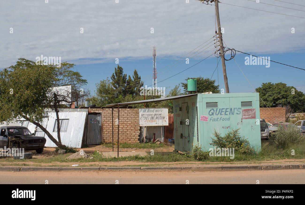 Chiosco chiuso per fast food o chiosco da portare via in un villaggio rurale della comunità africana circondato da vecchi edifici a Capo Nord, Sud Africa Foto Stock