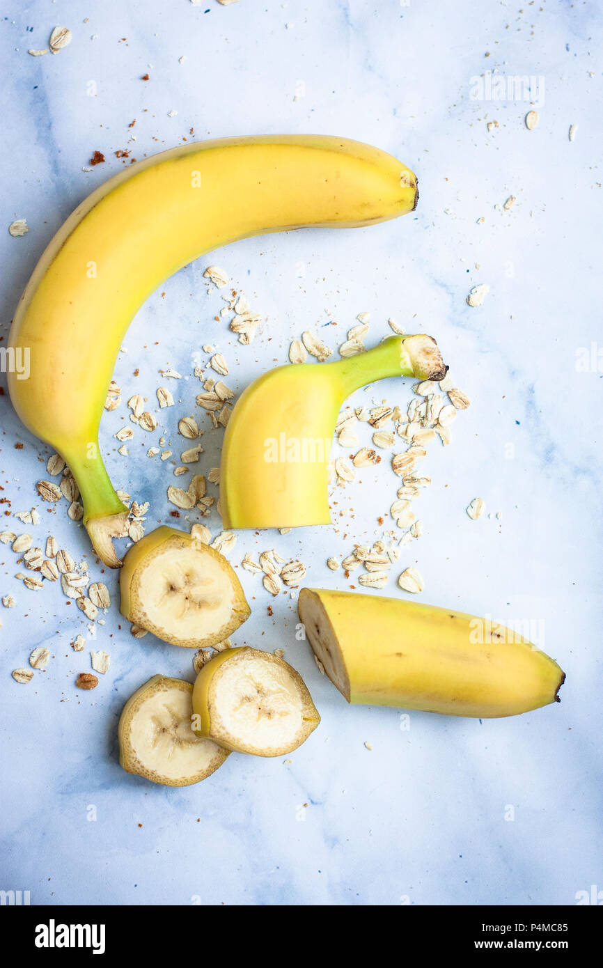 Tutta una banana e fette di banana con avena Foto Stock