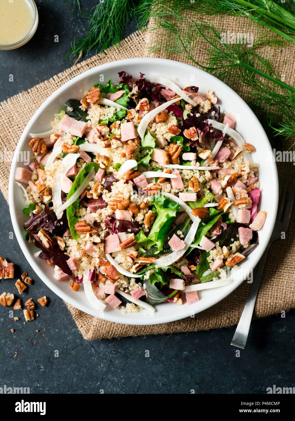 Prosciutto, finocchi e insalata di quinoa su sfondo scuro Foto Stock