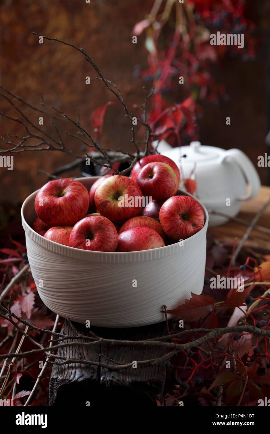 Le mele rosse in una ciotola bianco Foto Stock