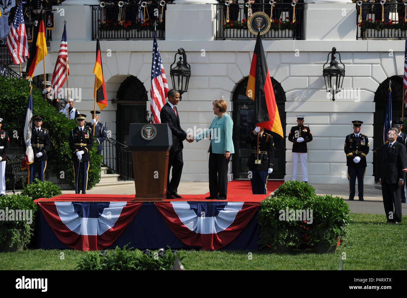 WASHINGTON, D.C. (7 giugno 2011) Il Presidente Barack Obama accoglie favorevolmente il Cancelliere Angela Merkel il podio a consegnare commento durante la cerimonia di arrivo accogliente il Cancelliere della Repubblica federale di Germania, Dott.ssa Angela Merkel. Arrivo militare cerimonie per dignitari sono state detenute sul prato Sud della Casa Bianca poiché l'amministrazione Kennedy. Foto Stock