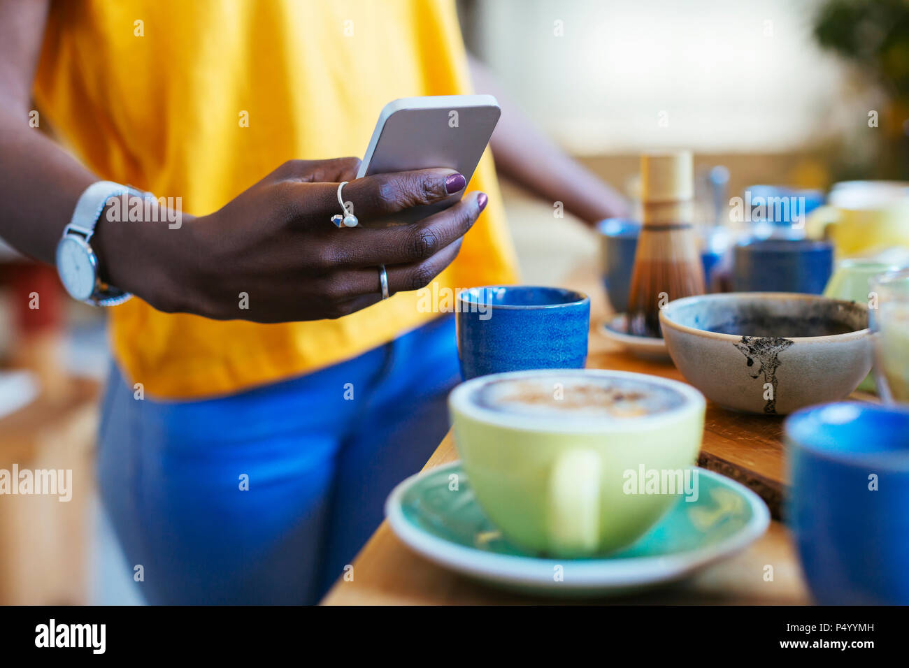 Donna prendendo immagini dello smartphone di bere in cucina Foto Stock