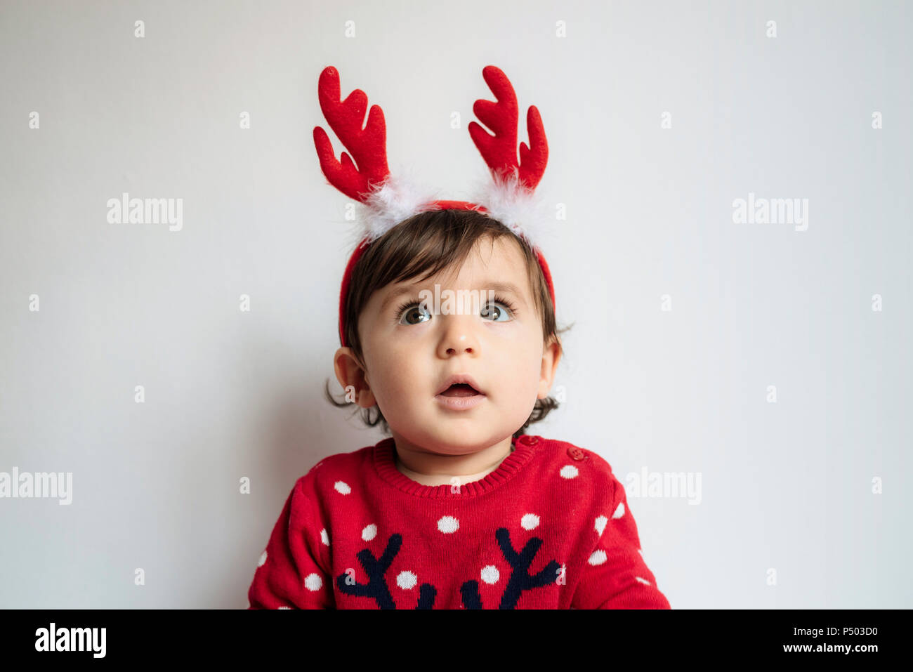 Ritratto di stupito bambina indossa le renne palchi con archetto Foto Stock