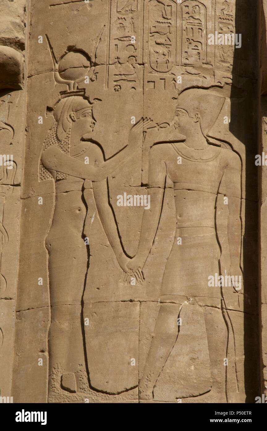 L'Egitto. Edfu. Tempio di Horus. Rilievo raffigurante una divinità egiziane dando la chiave della vita ankh, al faraone. Foto Stock