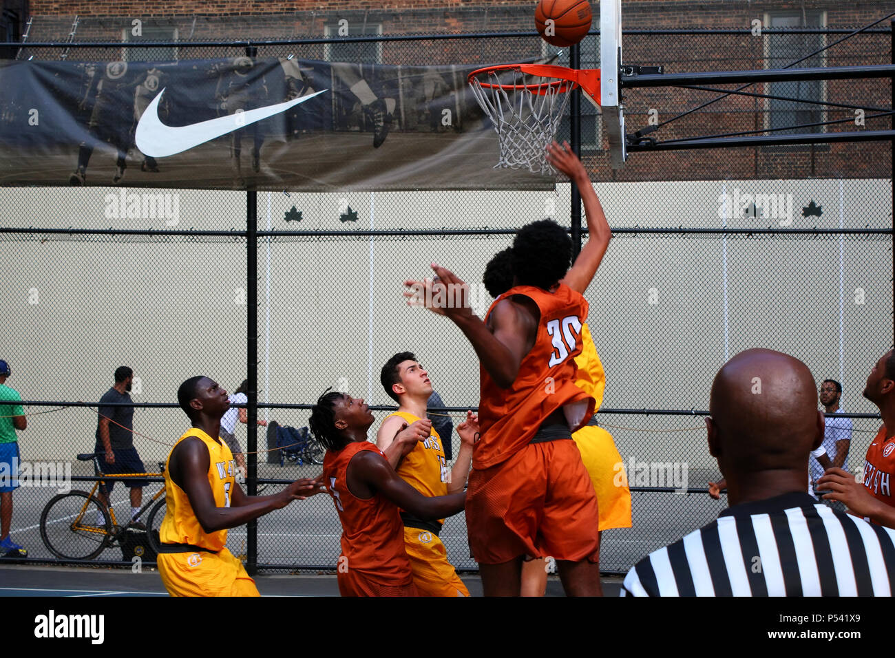 NEW YORK, NY - Luglio 12: scomposizione dei giocatori per la palla sotto il bordo mentre giocando a basket in "gabbia", West 4th Street tribunali, Manhattan su J Foto Stock