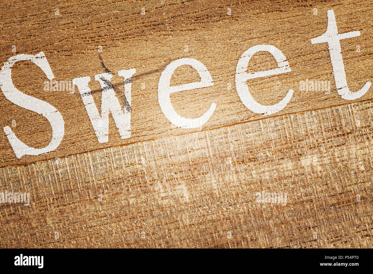Parola dolce stampato su un asse di legno. Foto Stock