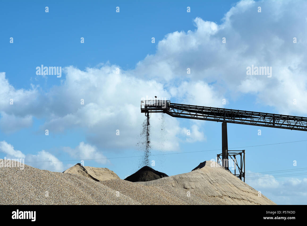 Montagne di sabbia e ghiaia in una cava di ghiaia Foto Stock