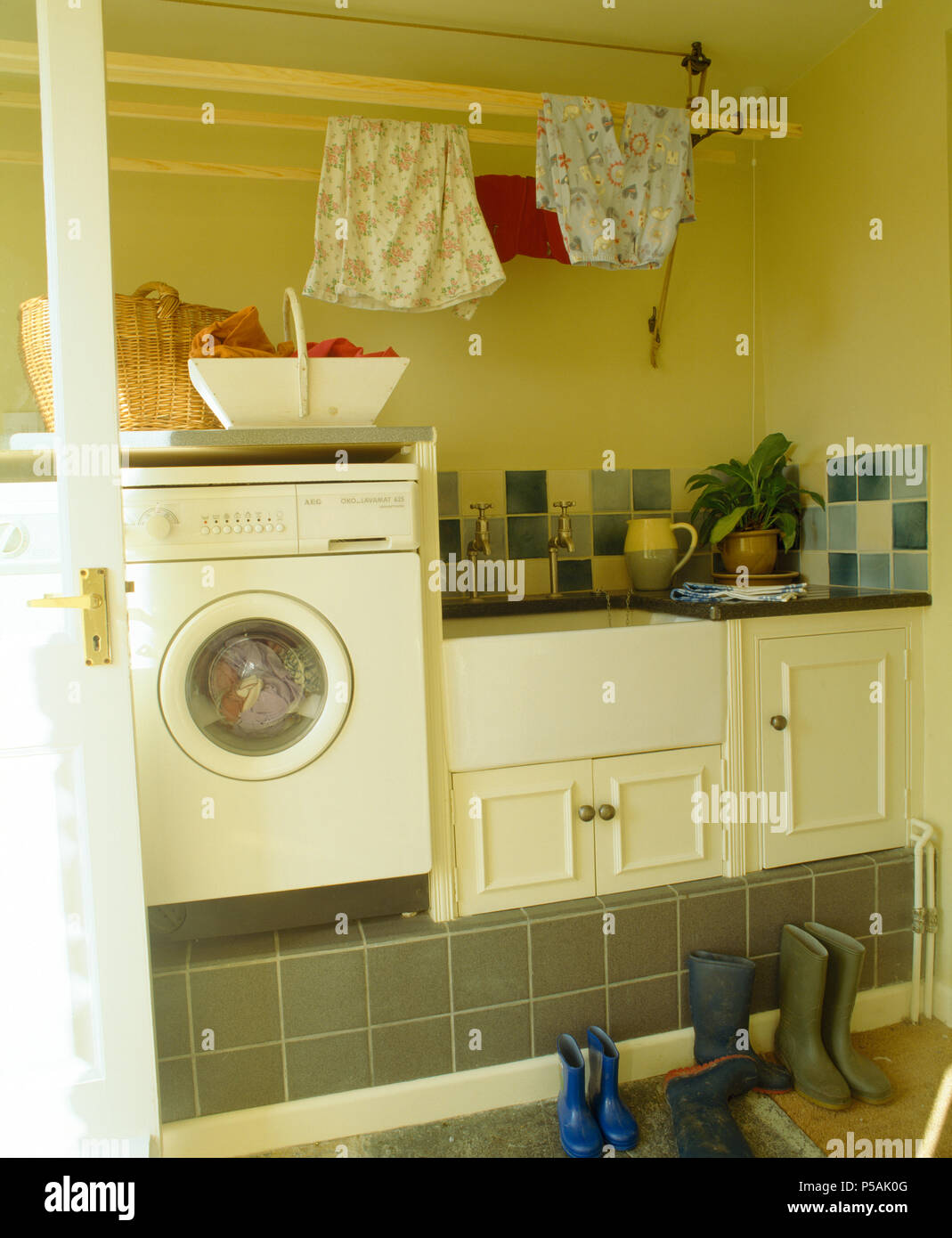 Macchina di lavaggio accanto al dissipatore in vecchio stile camera utility Foto Stock