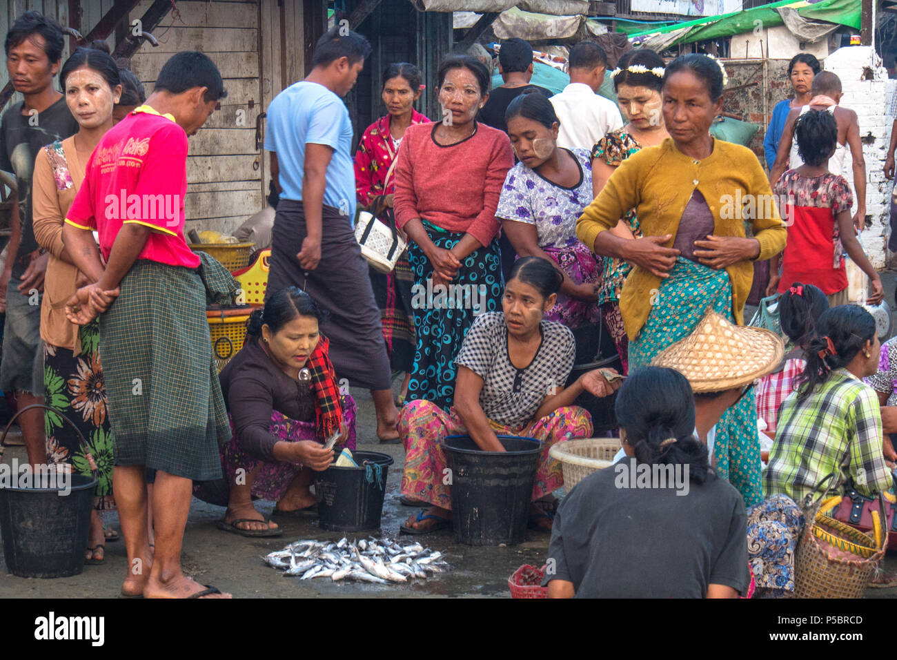 Le persone erano in attesa pescatore al molo per vendere il loro prodotto, Sittwe Myanmar Foto Stock