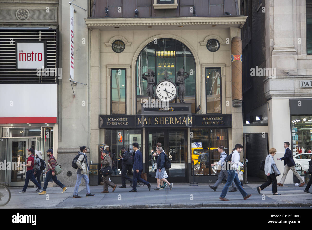 La gente a piedi su E. 42nd Street passato Nat Sherman, "Tabaccaio al mondo' nel centro di Manhattan. Foto Stock