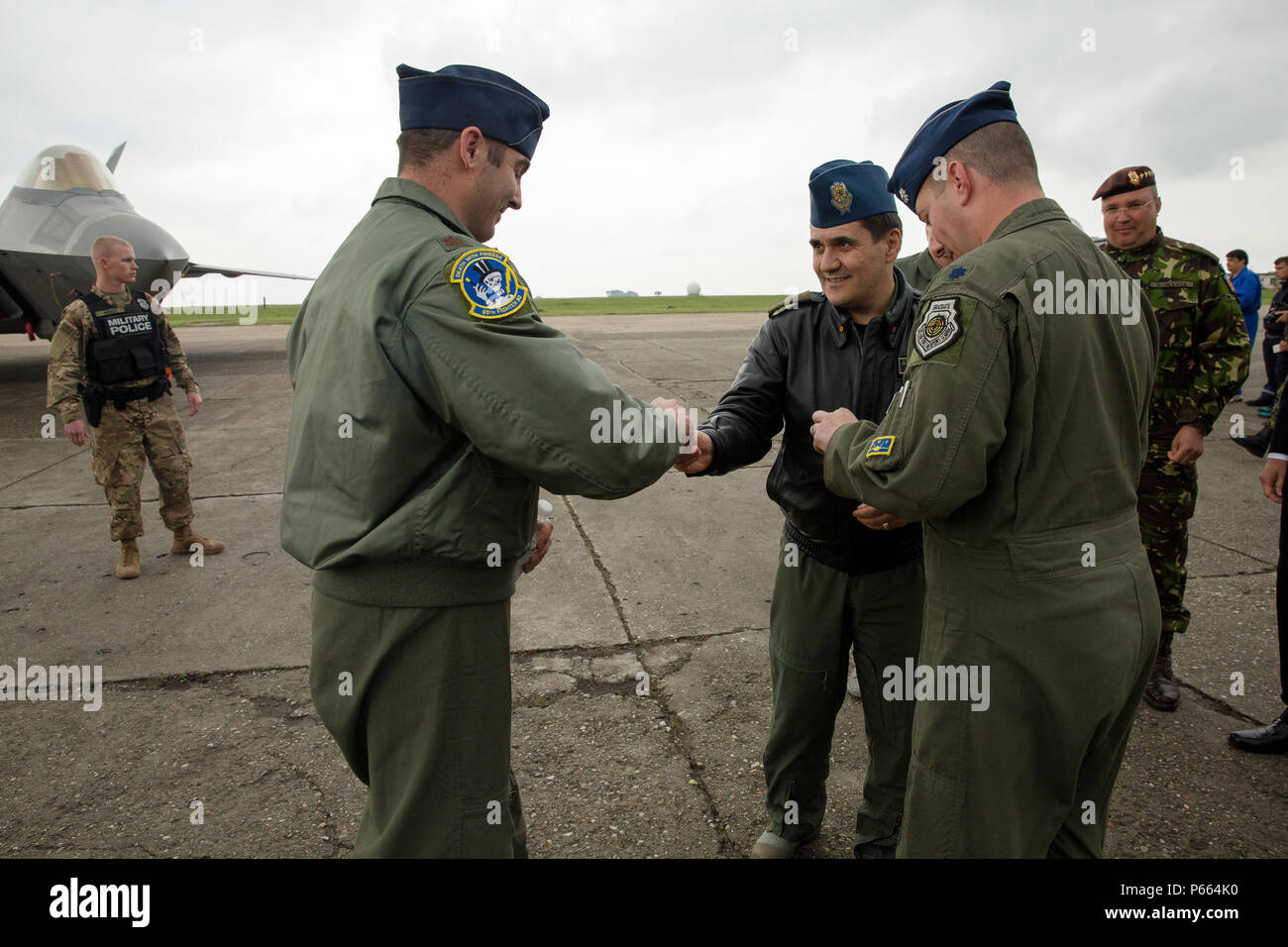 Romanian Air Force Il Mag. Gen. Laurian Anastasof, centro, Chief rumeno della Air Force Staff, incontra con gli Stati Uniti Air Force fighter piloti davanti a un F-22 visualizzazione statica prima di tenere una conferenza stampa con locale Romanian media outlet a bordo Mihail Kognalniceanu Air Base, Romania, 25 aprile 2016. Il velivolo sarà condotta aria formazione con altre con base in Europa e di aeromobili trasmetterà inoltre distribuire dall'Inghilterra per massimizzare le opportunità di formazione pur dimostrando l'impegno degli Stati Uniti per gli alleati della NATO e la sicurezza dell'Europa. (U.S. Marine Corps foto di Cpl. Kelly L. Street, 2D MARDIV COMCAM Foto Stock