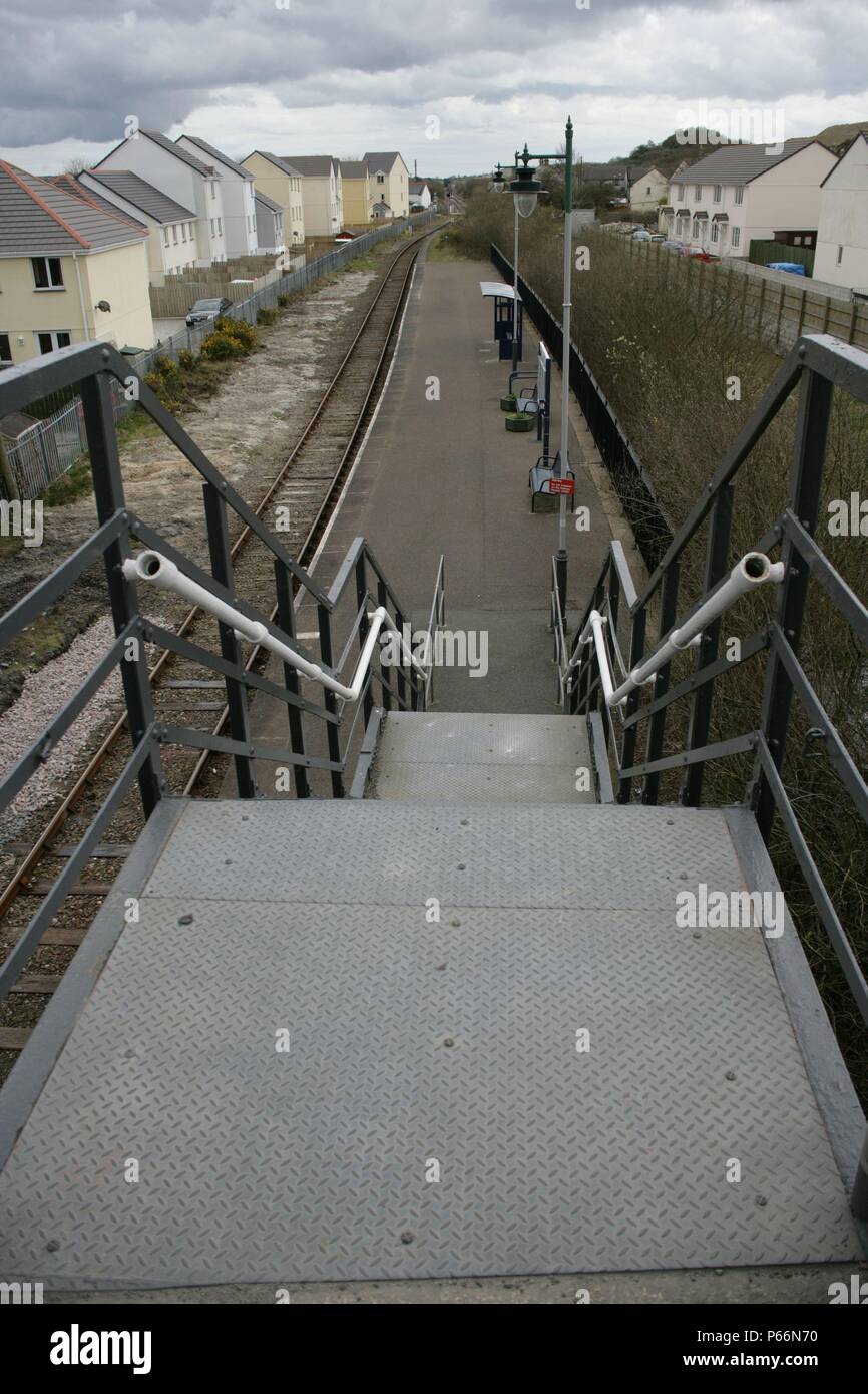 Ingresso alla piattaforma alla stazione Bugle, Cornwall, dal ponte stradale e mostrando come la stazione si trova nel cuore della comunità che serve. 20 Foto Stock