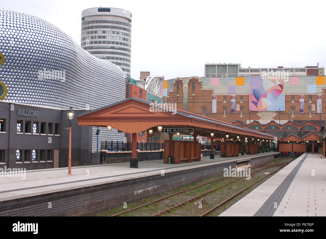 Il vecchio incontra il nuovo in questa vista di Birmingham Moor St stazione dalla estremità del sud della piattaforma 3 guardando a nord verso il famoso Rotunda e l'ultra moderna Bu Foto Stock
