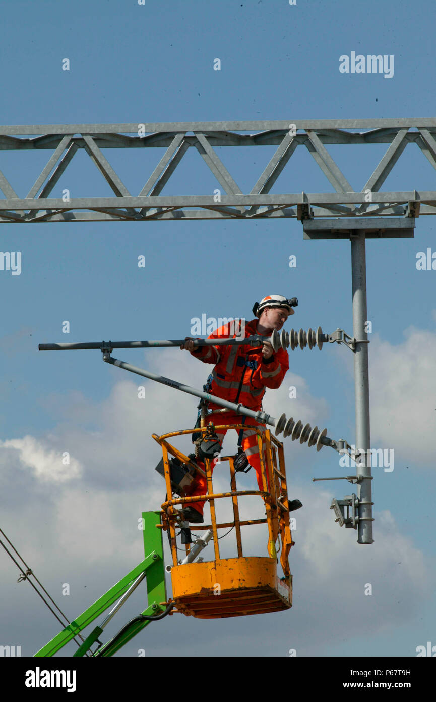 Rinnovando la catenaria di overhead da cherry picker montato su strada-railer a Bourne End. Agosto 2003 durante la linea principale della costa occidentale di aggiornamento. Foto Stock