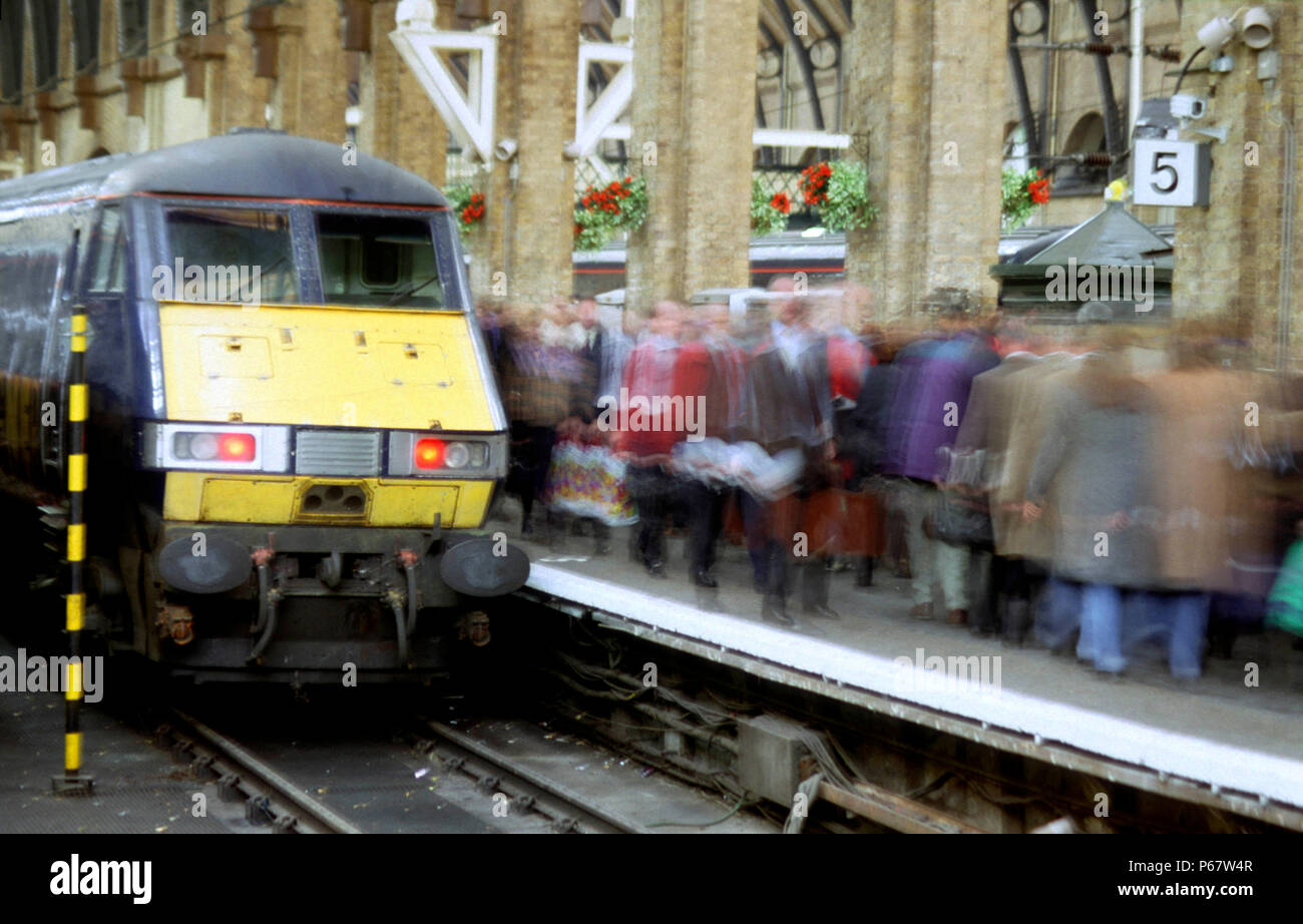 La classe 82/2 DVT a Kings Cross tamponi segna l'arrivo di un servizio GNER da nord come passeggeri frettolosi passato sulla piattaforma di occupato. Foto Stock