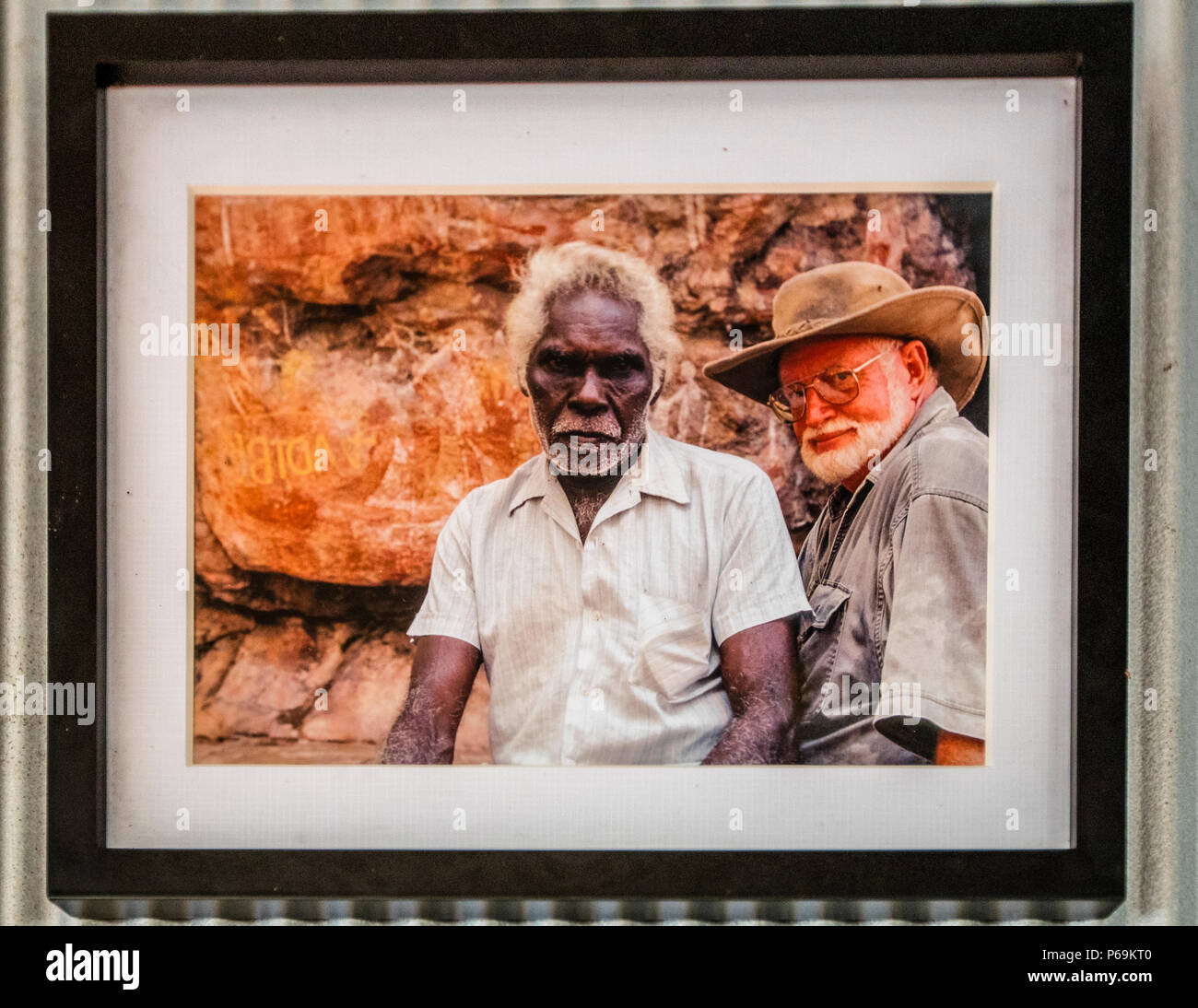 Una fotografia incorniciata a Davidson's Lodge nel Territorio del Nord, in Australia, mostra il defunto pioniere dell'outback Max Davidson (a destra) con Big Charly, un anziano dei proprietari tradizionali delle terre, davanti a una pittura rupestre. Foto Stock