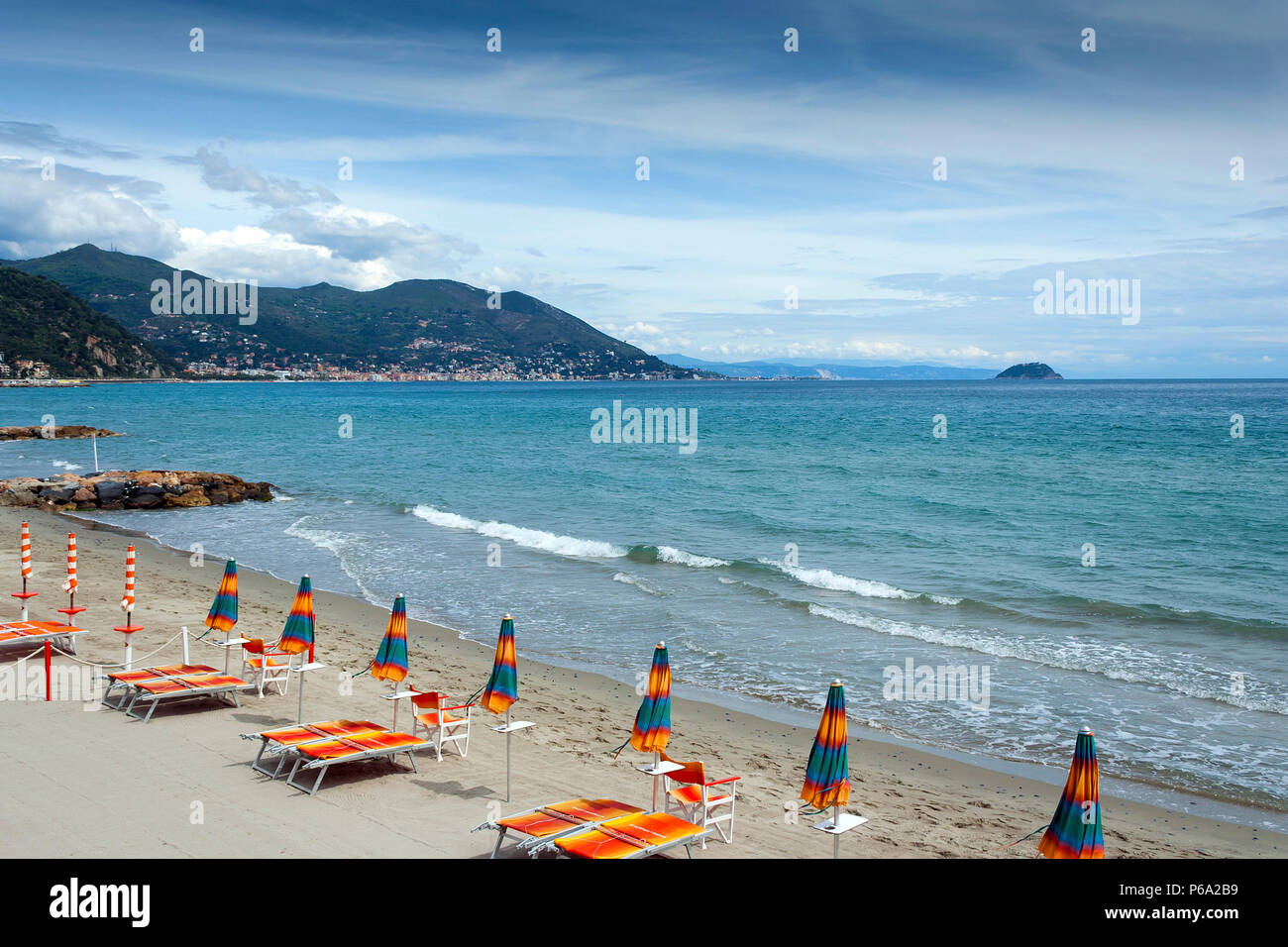 Laigueglia spiaggia in Liguria Italia con sedie a sdraio e ombrelloni in una calda giornata estiva Foto Stock