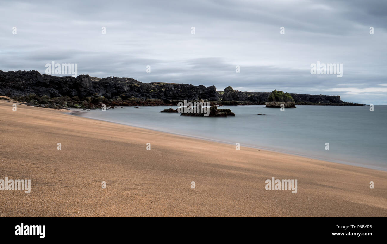 Spiaggia di Skardsvik. unica spiaggia dorata in Islanda con pietra vulcanica scogliere. nice Foto Stock