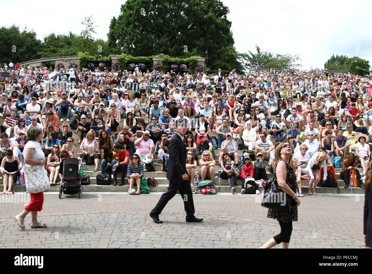 Vista frontale di Henman Hill a Wimbledon Lawn Tennis campionati con una folla focalizzato guardando il grande schermo. Foto Stock