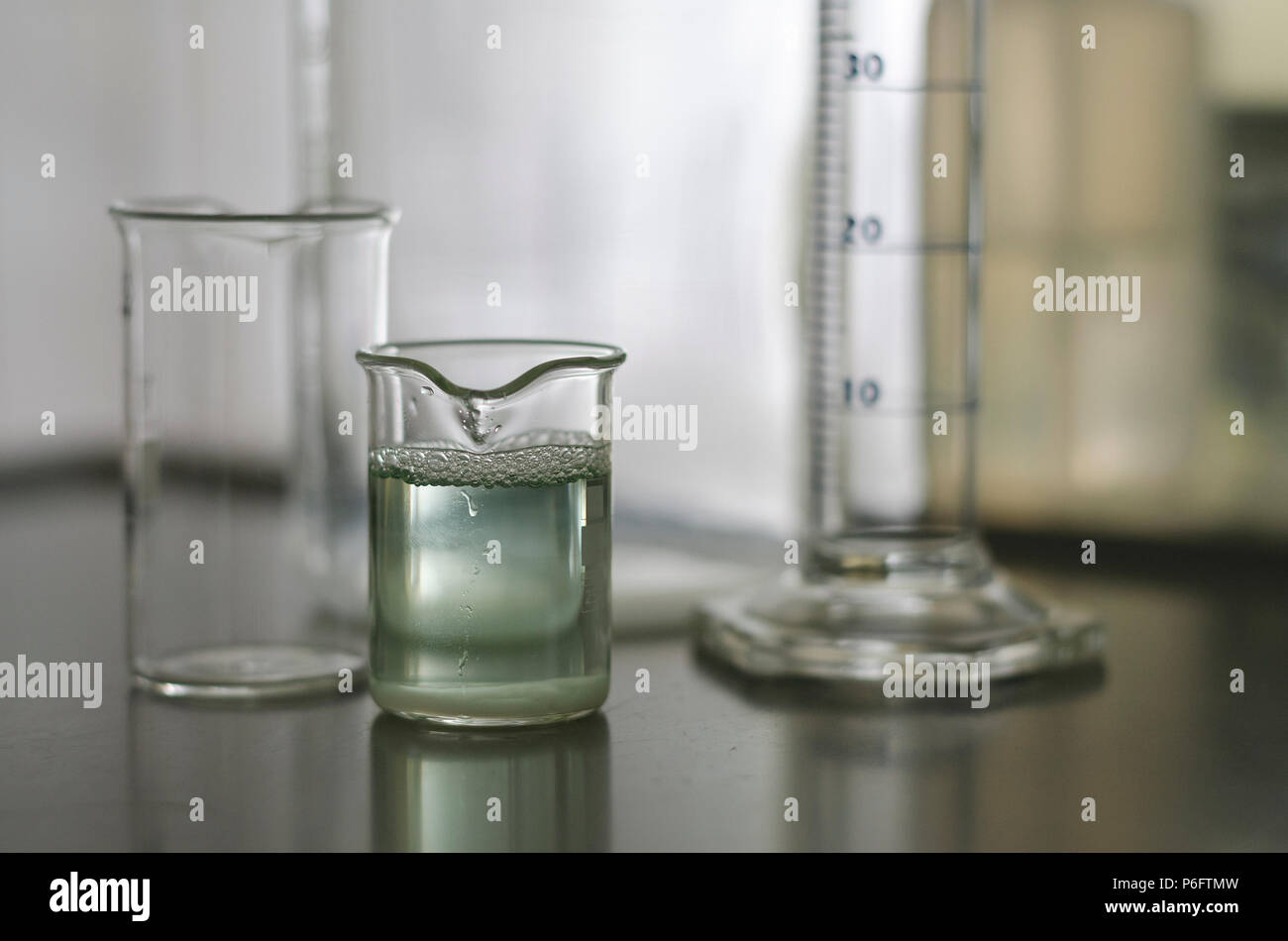 Campione di acqua nel tubo di vetro con colorazione verde gradiente Foto Stock