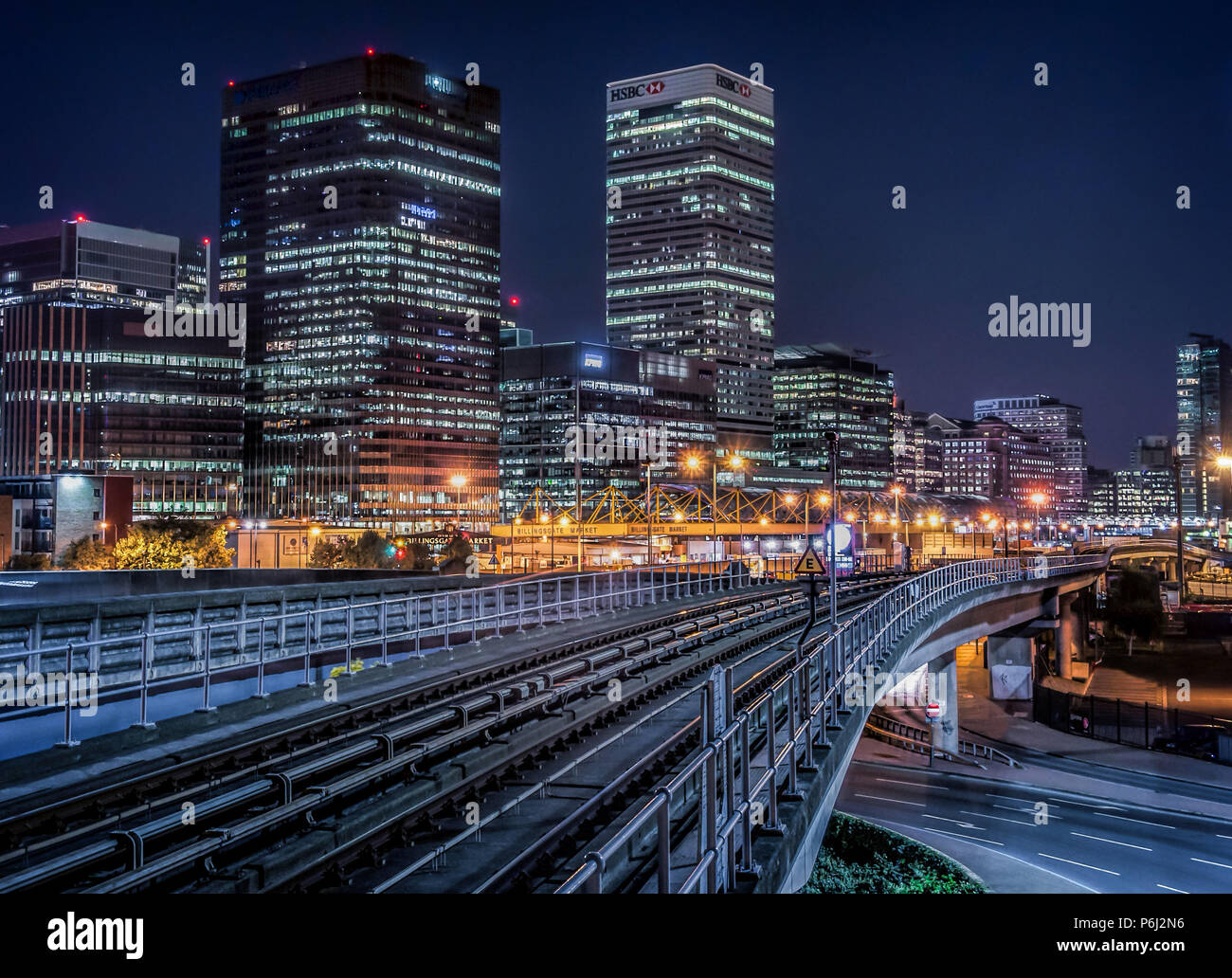 30 Settembre 2015 - Londra, Inghilterra. Notte futuristico cityscape vista della DLR railroad che conduce al quartiere finanziario torri di Canary Wharf, Londo Foto Stock