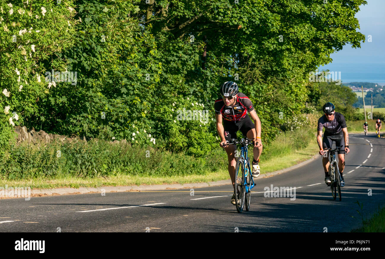 Byres Hill, East Lothian, Scozia, Regno Unito, 1 luglio 2018. Edinburgh IRONMAN 70.3, Byres Hill, East Lothian, Scozia, Regno Unito, 1 luglio 2018. Ciclismo parte dell'evento sportivo endurance. I concorrenti si lanciano in bicicletta in salita passando da Byres Hill su un percorso ciclistico di 56 km dopo aver completato la nuotata prima di una corsa di 26.1 km come parte dell'evento Triathlon Foto Stock