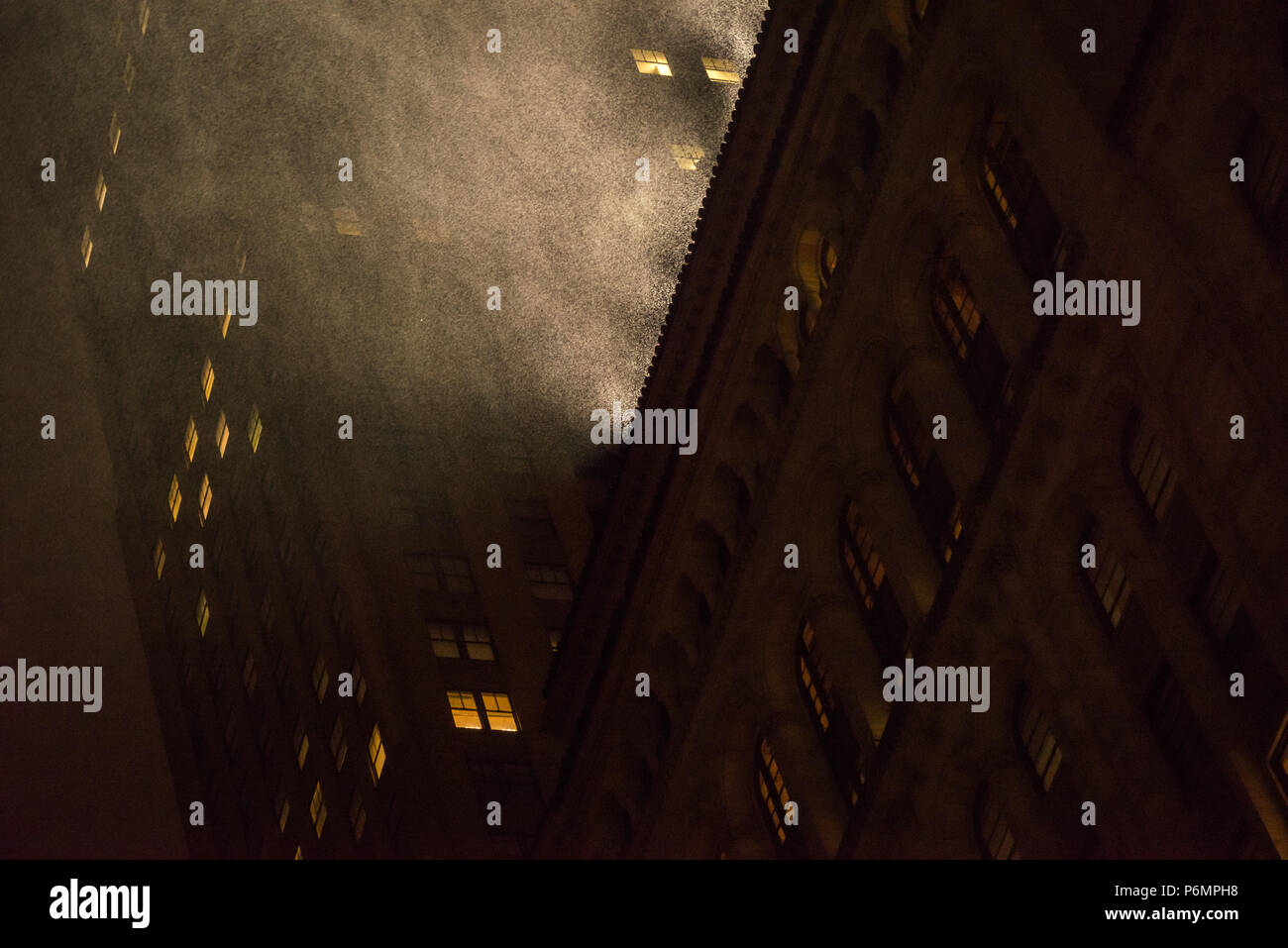 Heavy Rain è evidenziata byroof top luce proiettore a Manhattan, New York City Foto Stock