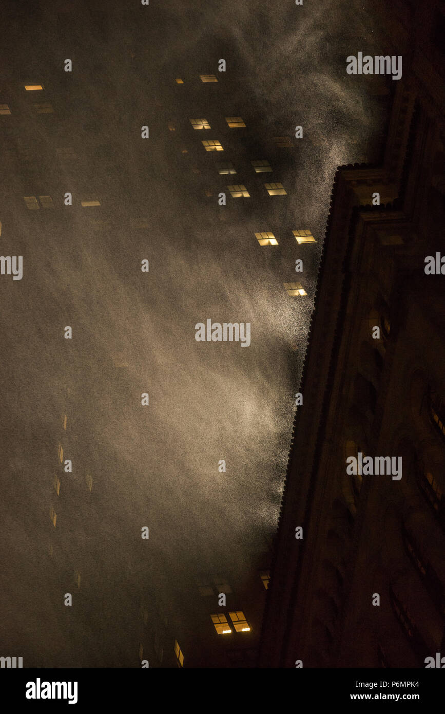 Heavy Rain è evidenziata byroof top luce proiettore a Manhattan, New York City Foto Stock