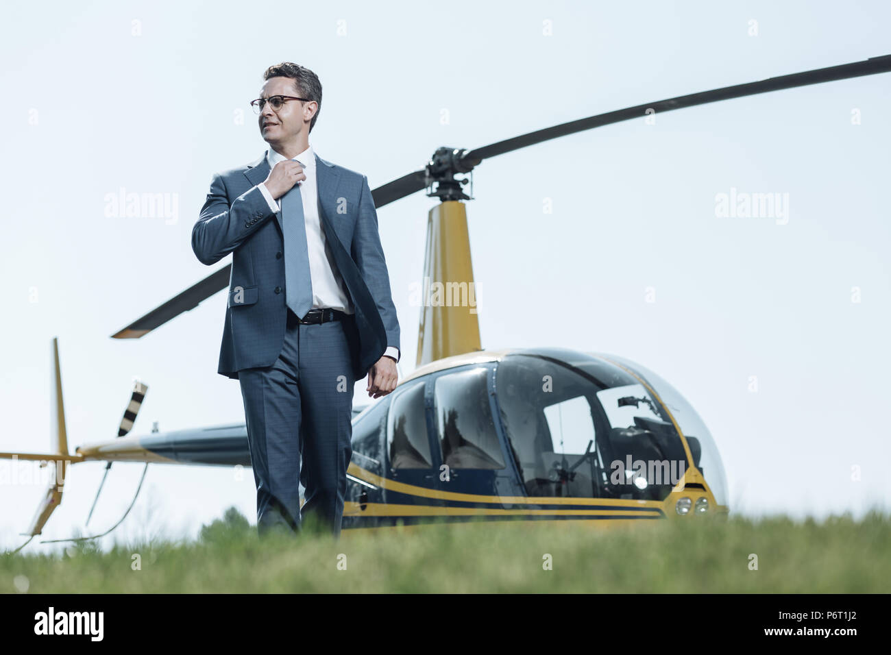 Affascinante agente speciale in piedi in un eliporto Foto Stock