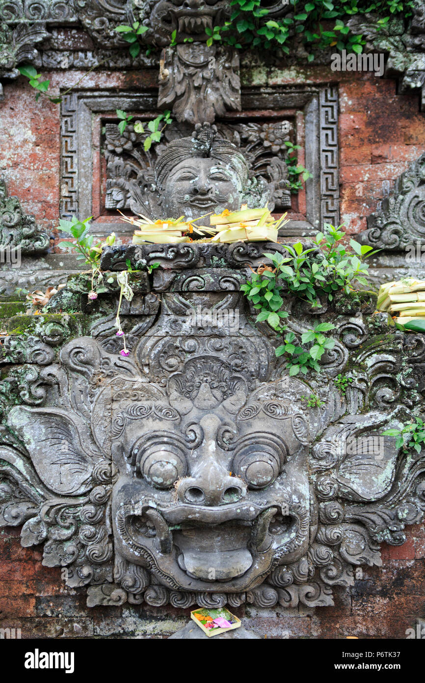 Asia Indonesia Bali Ubud, Balinese tradizionale sculture indù in un santuario di strada accanto a un tempio Foto Stock
