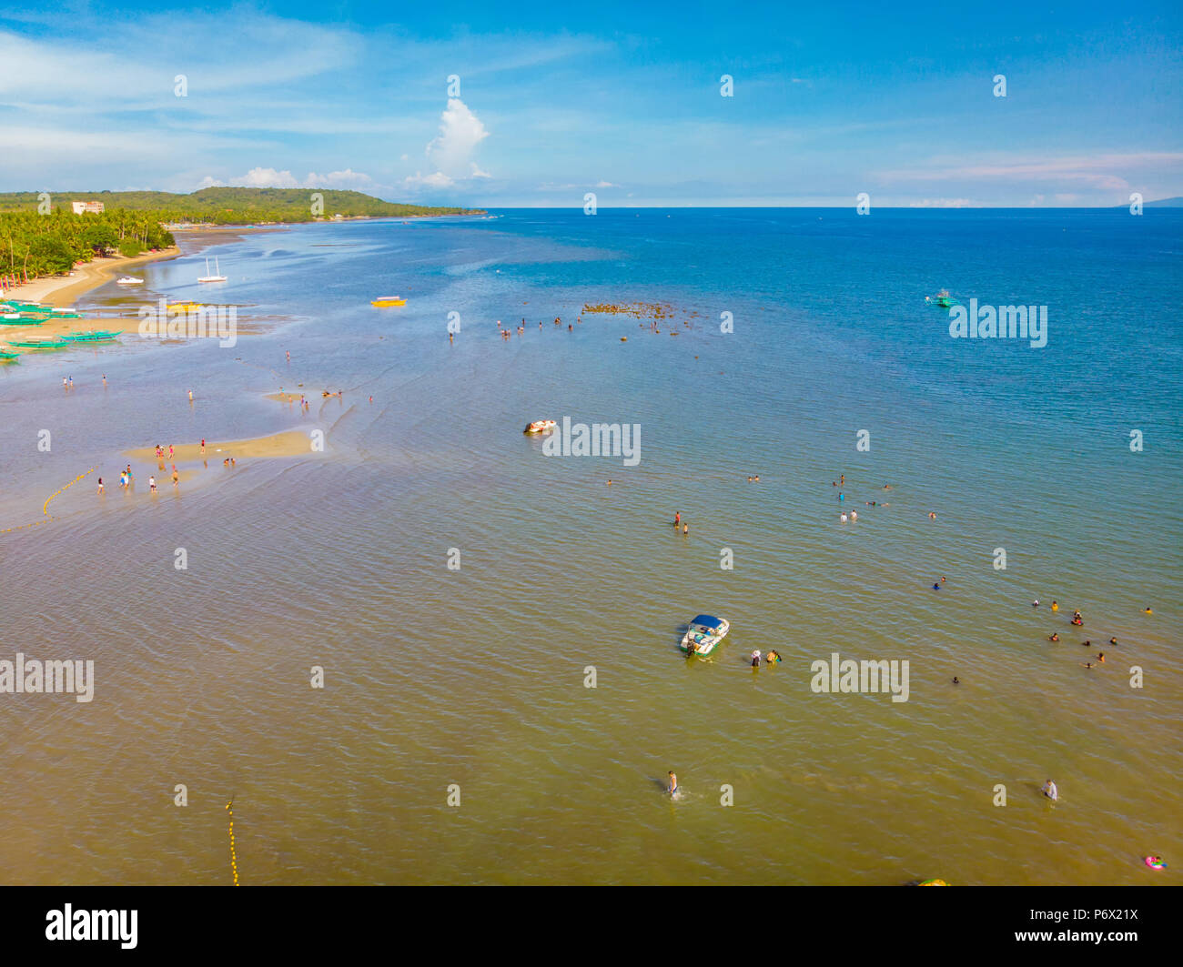 Skyline di Laiya, San Juan, Batangas e il sorgere di una minuscola isola di marea come risultato della bassa marea Foto Stock