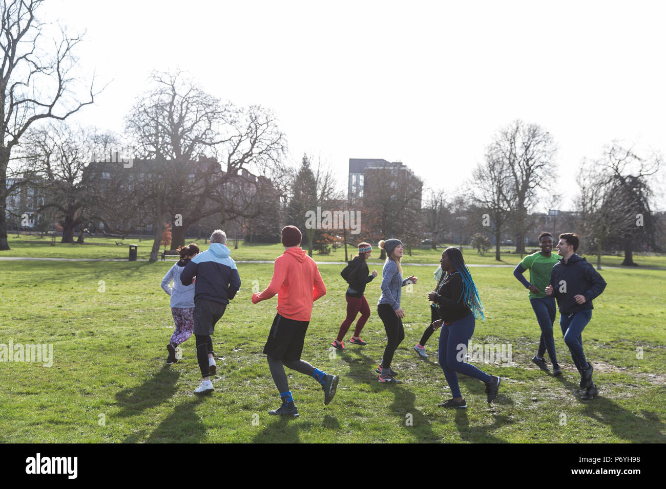 Guide di scorrimento a fare jogging nel cerchio nel soleggiato parco Foto Stock