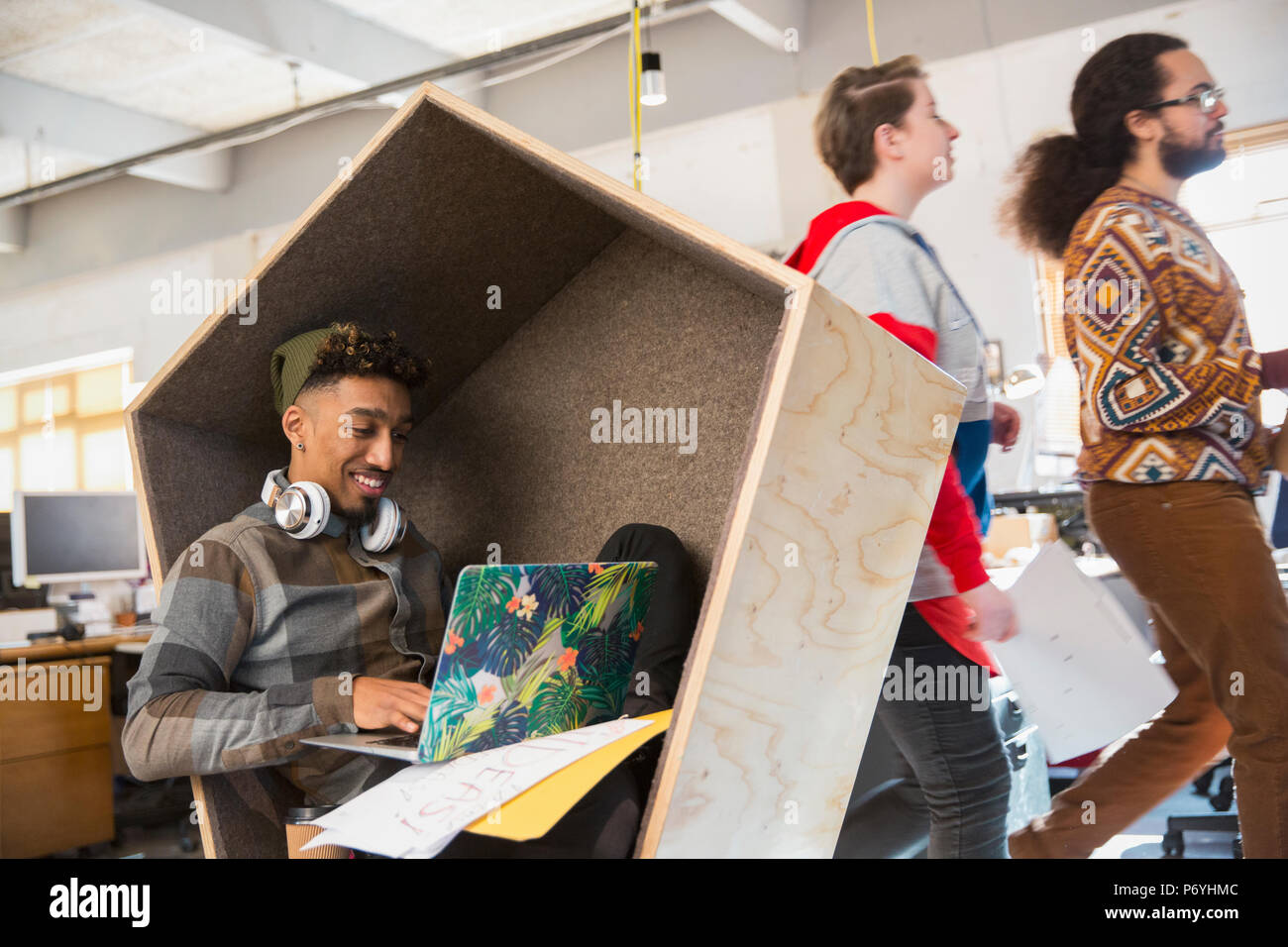 Imprenditore creativo lavorando al computer portatile nel vano portaoggetti Foto Stock