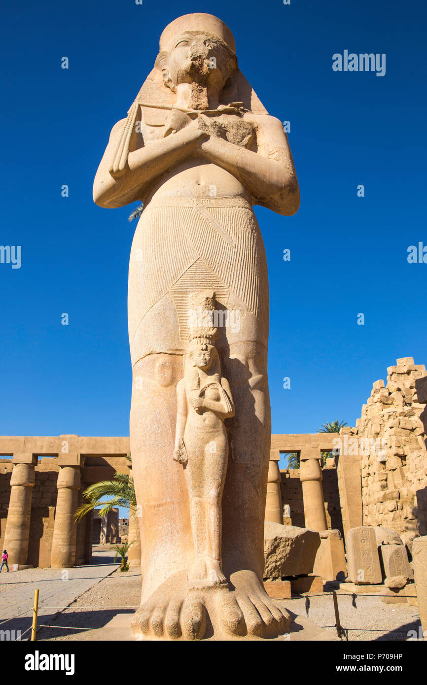 Egitto Luxor Tempio di Karnak, colossale statua di re Ramesse II con sua figlia piegate'anta Foto Stock