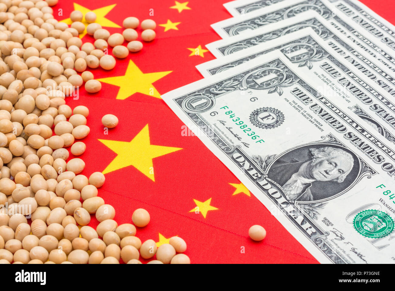 Bandiera cinese con noi 1 fatture del dollaro e semi di soia secchi - metafora per USA-Cina guerra commerciale cinese e tariffe su di noi le importazioni di soia, guerra commerciale in Cina. Foto Stock