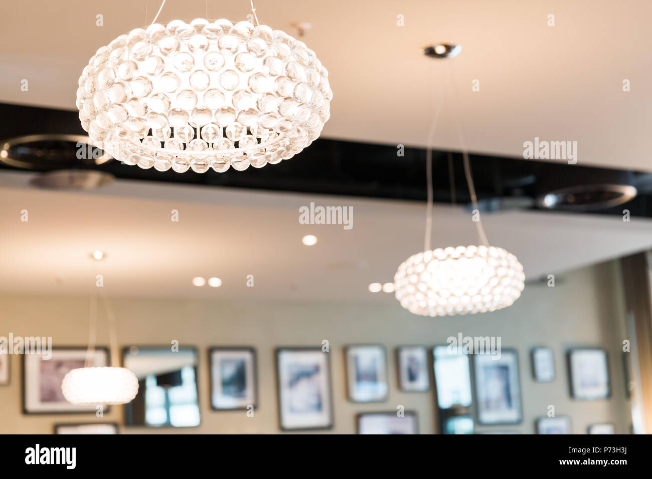 Illuminata rotonda illuminazione a soffitto nel ristorante con sfondo sfocato Foto Stock