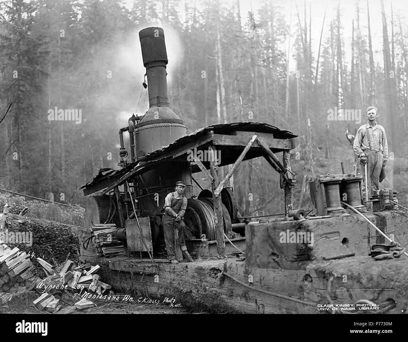 . Inglese: Asino motore ed equipaggio, Wynooche Timber Company, vicino Montesano, ca. 1921 . Inglese: didascalia sull'immagine: Wynoche Log. Co., Montesano, Wn. C. Kinsey foto, Seattle. No. 64 PH Coll 516.5161 Il Wynooche Timber Company ha iniziato le operazioni di ca. 1913 con sede a Hoquiam e operazioni di registrazione in Montesano. È stato chiamato con il nome di Valle Wynooche nella zona nord-est di Grays Harbor County. Wynooche Timber Company è stato comprato dalla Schafer Fratelli Logging Company ca. 1927. Montesano, la sede della contea di Grays Harbor County, è otto miglia a est di Aberdeen sul fiume Chehalis vicino alla bocca del Wynooche Foto Stock