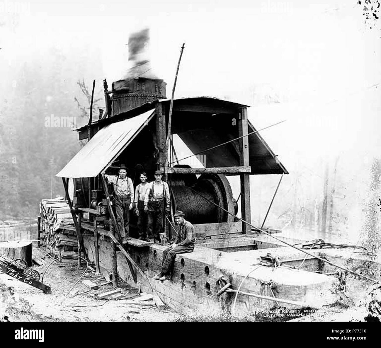 . Inglese: Asino motore ed equipaggio, con gas powered vide utilizzato per il taglio di legno per combustibile, Wynooche Timber Company, vicino Montesano, ca. 1921 . Inglese: didascalia sull'immagine: Wynooche Tmbr. Co. No. 418 PH Coll 516.5195 Il Wynooche Timber Company ha iniziato le operazioni di ca. 1913 con sede a Hoquiam e operazioni di registrazione in Montesano. È stato chiamato con il nome di Valle Wynooche nella zona nord-est di Grays Harbor County. Wynooche Timber Company è stato comprato dalla Schafer Fratelli Logging Company ca. 1927. Montesano, la sede della contea di Grays Harbor County, è otto miglia a est di Aberdeen sul fiume Chehalis vicino al mou Foto Stock