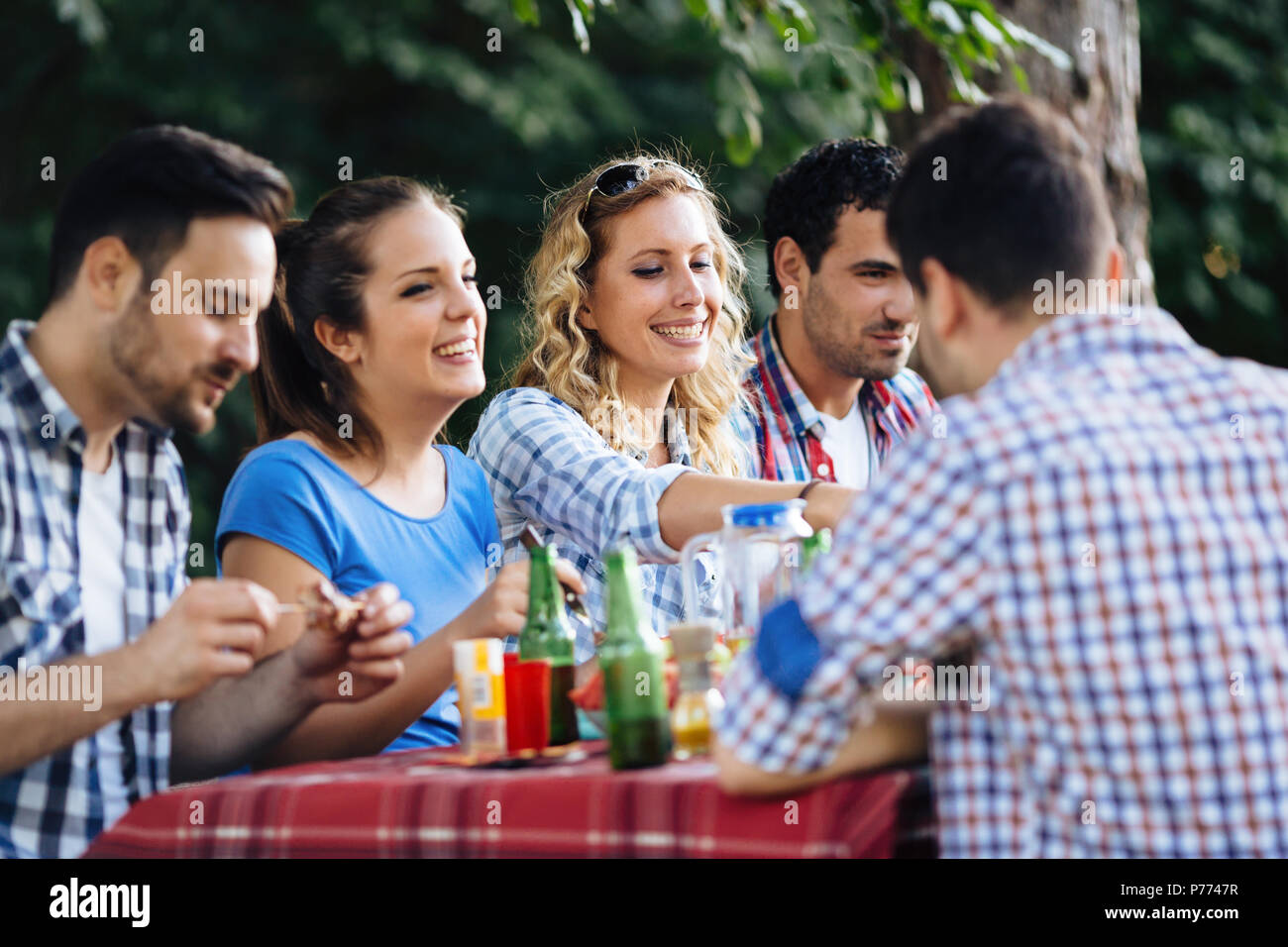 Gruppo di persone contente e mangiare all'aperto Foto Stock