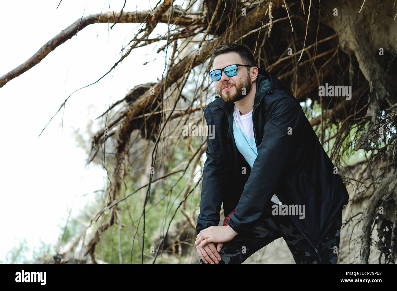 Giovane uomo barbuto, vestito in abiti giovanili, viaggia per mare, le avventure in una calda giornata estiva. Foto Stock