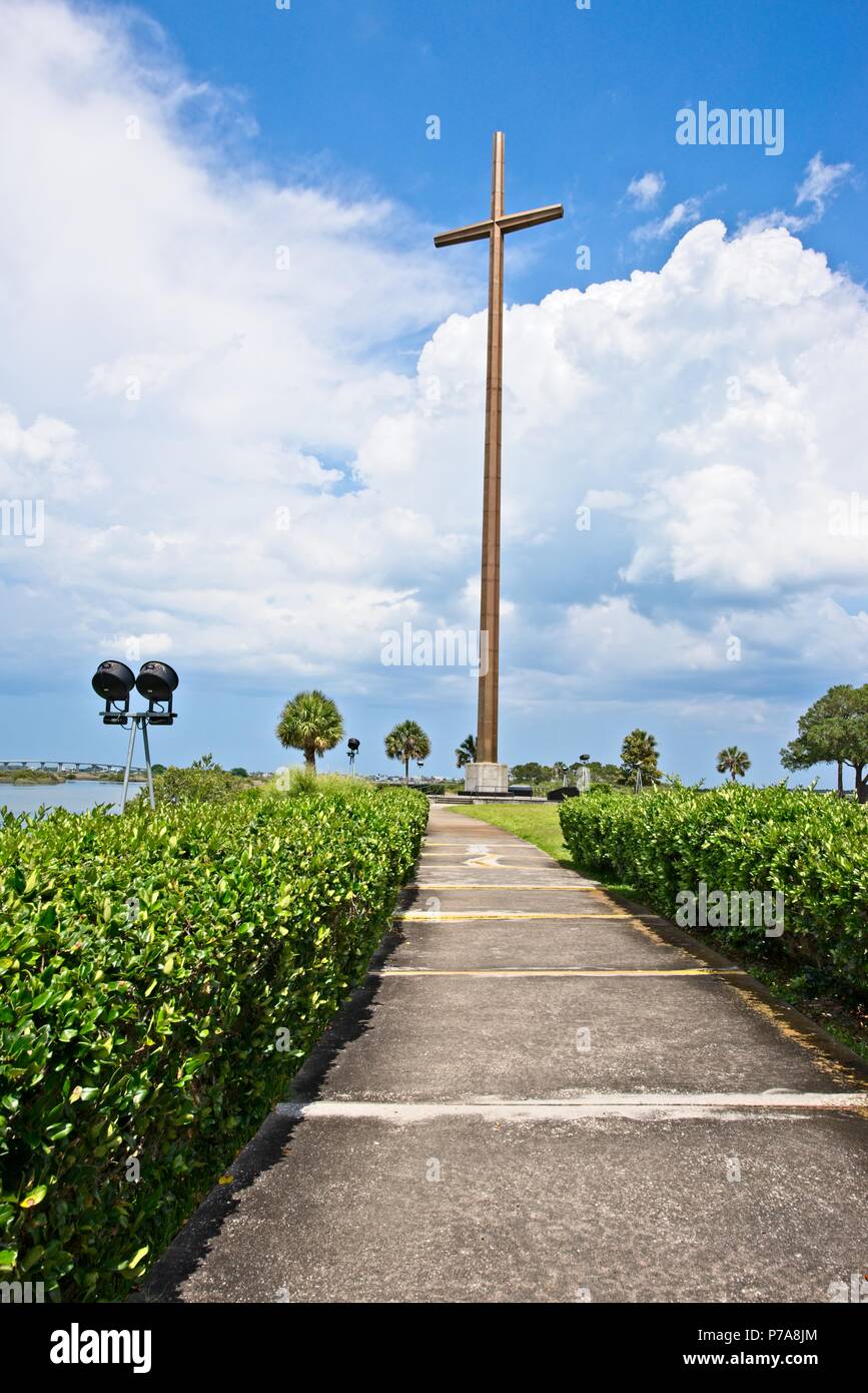 La croce, un simbolo del cristianesimo si trova lungo la tranquilla acqua Foto Stock