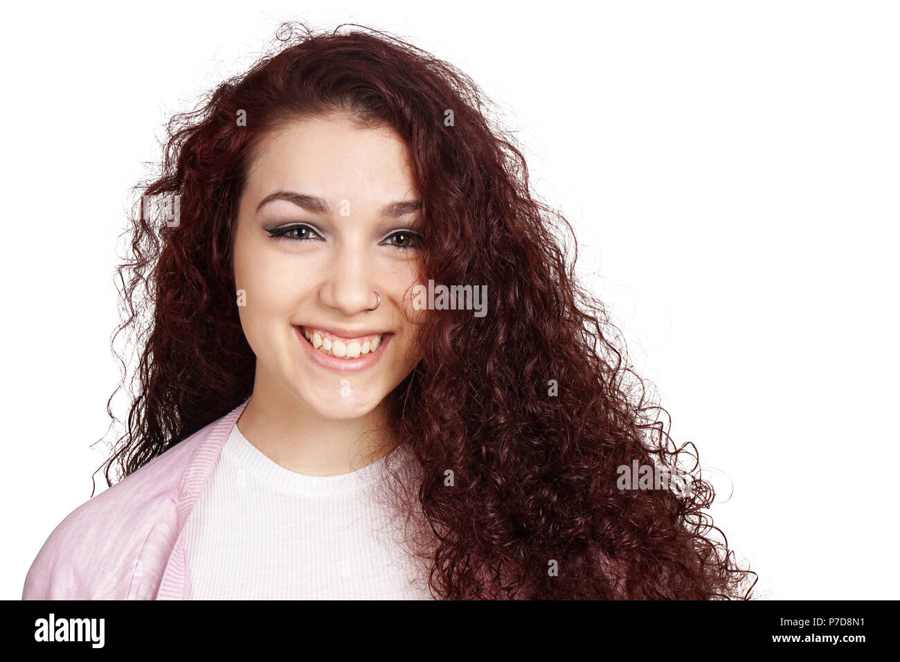 Felice ragazza adolescente con lunghi capelli ricci e sorriso toothy isolato su bianco Foto Stock