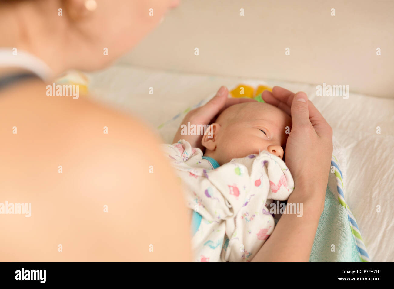 Madre la sua consolante un neonato dopo il cambio dei pannolini Foto Stock