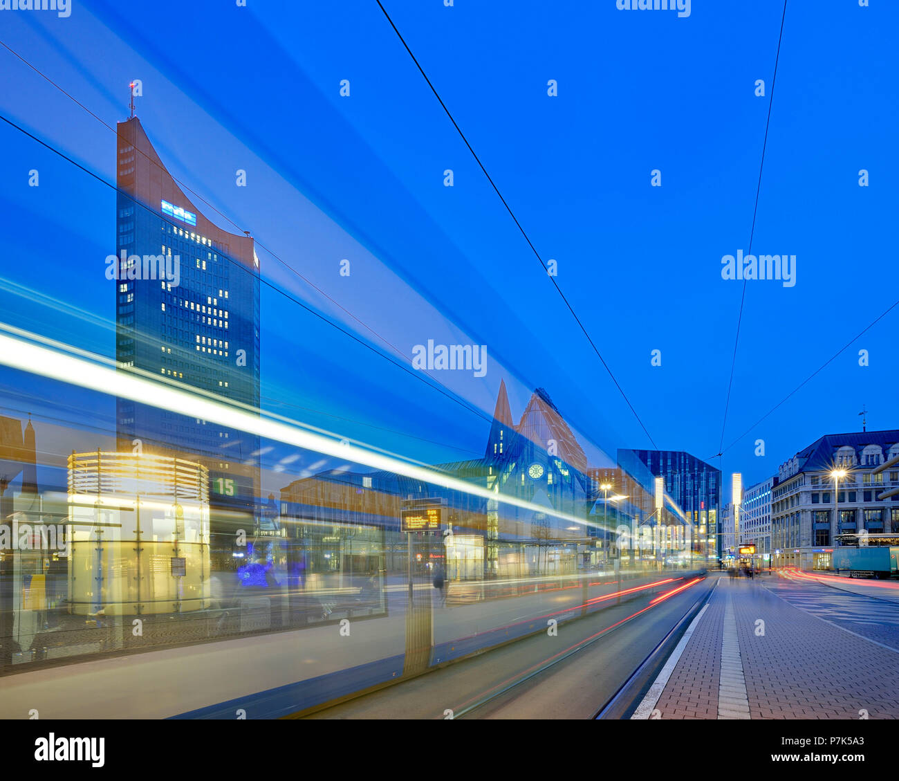 In Germania, in Sassonia, Lipsia, il Augustusplatz con 'Città Hochhaus' così come l Augusteum e Paulinum University, night shot con luce tracce di tram Foto Stock