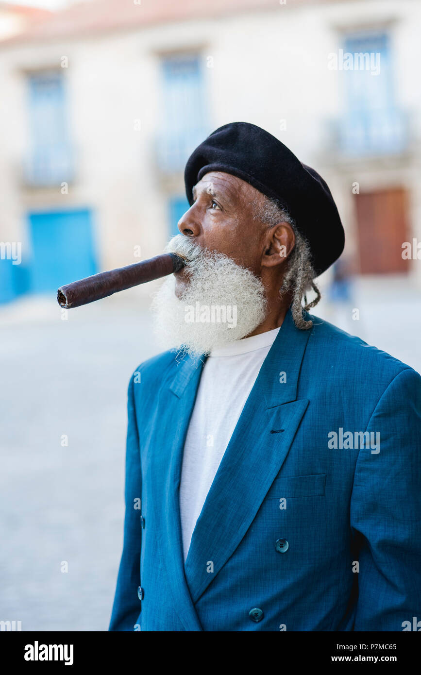 Un impeccabilmente vestito che fumare un sigaro gigante nelle strade di l'Avana, Cuba. Egli è stato presentato nel National Geographic Traveler anni fa. Foto Stock